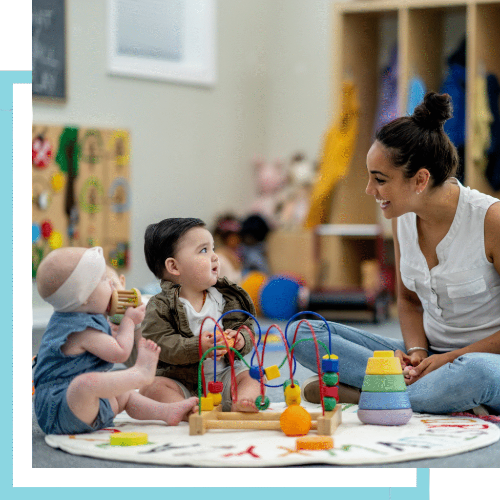 Teacher playing with babies in daycare program